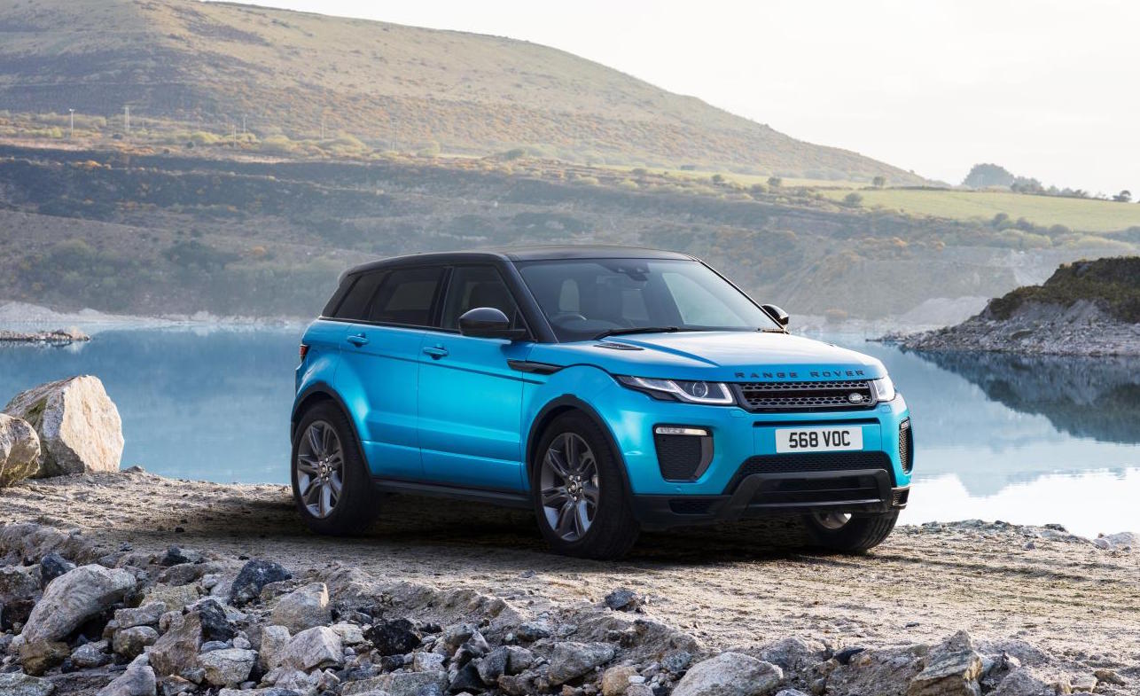 Blue Range Rover Evoque, facing right, parked next to a lake.
